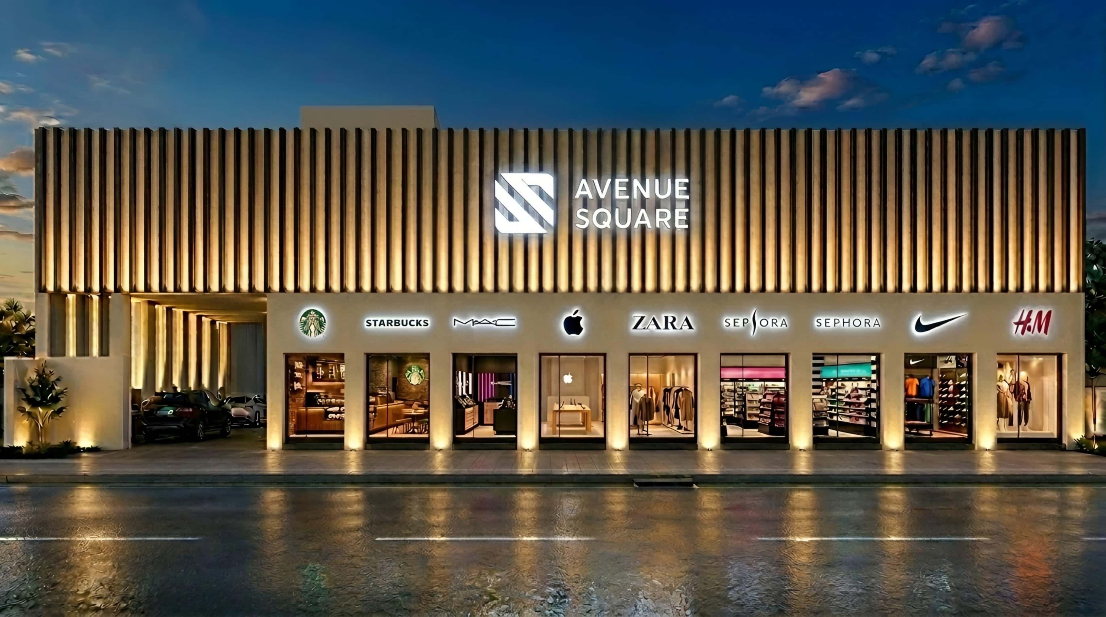 Illuminated retail facade with vertical fin cladding at dusk, storefront lighting reflected in the wet asphalt
